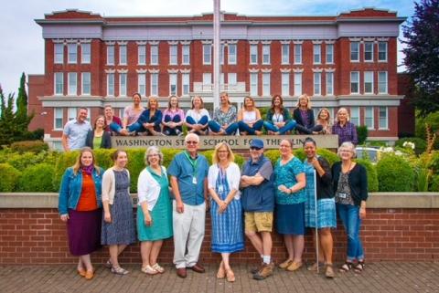 Outreach team standing in front of the Old Main building at WSSB