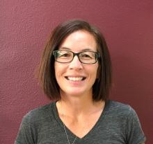 Headshot of Danielle Kala, a middle-aged Asian-American woman with shoulder-length brown hair and glasses.