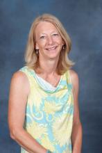Lori Pulliam, a smiling woman with blonde hair wearing a blue and yellow top experiencing a rare Zen moment.