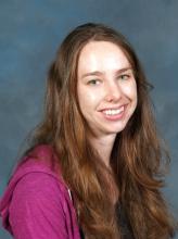 Carrie Tanner, a young woman with too-long reddish brown hair and a big smile! 