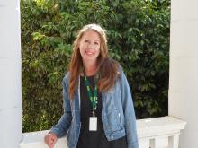 Heather standing outside of old main in front of bushes