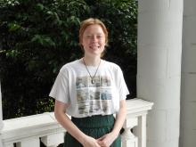 Kenedy standing outside of old main