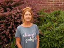 Linda standing outside of old main