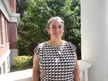 Taylor standing outside of the Old Main building