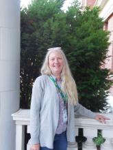 Pam smiling outside of the Old Main building