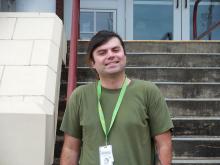 Christian standing outside of the Old Main building