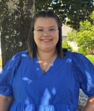 Rebecka smiling outside wearing a blue top