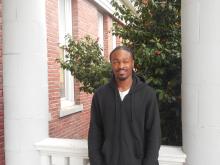 Kejona standing outside of the Old Main Building